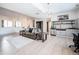 Open-concept living room includes a partial kitchen, modern lighting, and a comfortable sofa for relaxed living at 18155 Flowered Meadow Ln, Monument, CO 80132