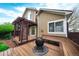 View of home's exterior and deck featuring a wood pergola, built-in bench seating, and spherical fire pit at 3565 W 112Th Cir, Westminster, CO 80031