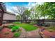 Beautifully landscaped backyard featuring stone pathways, mature trees, and a wood pergola over the back deck at 3565 W 112Th Cir, Westminster, CO 80031