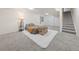 Spacious basement with plush gray carpet, accent rug, and stairs leading to the upper level at 3565 W 112Th Cir, Westminster, CO 80031