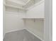 Bright, carpeted walk-in closet with white walls and multiple shelves for organized storage space at 3565 W 112Th Cir, Westminster, CO 80031