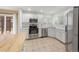 Clean kitchen with stainless appliances, white cabinets, and an island with natural wood countertop at 3565 W 112Th Cir, Westminster, CO 80031