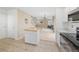 Open-concept kitchen flows into the living area, featuring stainless steel appliances and a functional island at 3565 W 112Th Cir, Westminster, CO 80031