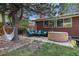 Backyard patio with hot tub, hammock and cushioned seating perfect for relaxation and entertaining at 120 Field St, Lakewood, CO 80226