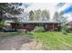 Enjoy outdoor living in the spacious backyard, featuring a patio area and lush greenery at 120 Field St, Lakewood, CO 80226