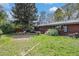 The brick exterior and luscious backyard provide an outdoor oasis perfect for relaxation and entertainment at 120 Field St, Lakewood, CO 80226