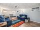 Finished basement area with hardwood floors, plush seating, and ample room for recreation at 120 Field St, Lakewood, CO 80226