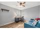 Cozy bedroom with a sofa and desk area, featuring natural light and hardwood floors at 120 Field St, Lakewood, CO 80226