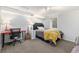 Cozy bedroom featuring a red desk, guitar, gray bed, and ample natural light from the window at 120 Field St, Lakewood, CO 80226