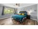 Spacious bedroom with hardwood floors, a large window, and a comfortable king-size bed with stylish decor at 120 Field St, Lakewood, CO 80226