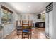 Cozy dining room featuring a wooden table set and vintage botanical wall art, open to the kitchen at 120 Field St, Lakewood, CO 80226