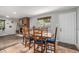 Dining room with wood table and brick fireplace, bathed in natural light from the window at 120 Field St, Lakewood, CO 80226