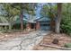 Inviting single-story home with brick accents, mature trees, landscaping and attached garage at 120 Field St, Lakewood, CO 80226