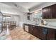 Bright kitchen with stainless steel appliances, granite countertops, dark cabinetry and tile floors at 120 Field St, Lakewood, CO 80226