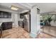 Well-lit kitchen with stainless steel appliances and dark wood cabinetry adjacent to the living room at 120 Field St, Lakewood, CO 80226