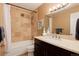 Clean and inviting bathroom featuring a shower-tub combo, dark vanity, and a well-lit mirror at 675 S Clinton St # 8B, Denver, CO 80247