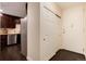 Entryway with wood floors and a closet next to an updated kitchen with stainless steel appliances at 675 S Clinton St # 8B, Denver, CO 80247