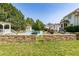 Serene backyard with lush greenery, a sparkling pool, and inviting outdoor spaces perfect for relaxation at 4245 S Dawson St, Aurora, CO 80014