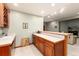 Wet bar area features wood cabinets, tile counter, sink and wine storage at 4245 S Dawson St, Aurora, CO 80014