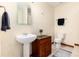 Bathroom features vanity sink, decorative mirror, toilet, and towel rack at 4245 S Dawson St, Aurora, CO 80014