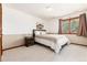 Bright bedroom with a queen bed and a large window at 4245 S Dawson St, Aurora, CO 80014