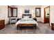 Comfortable bedroom with a wooden-framed bed, plush carpet, and shuttered windows at 4245 S Dawson St, Aurora, CO 80014