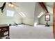 Bright bonus room with many skylights, carpet, and gym equipment at 4245 S Dawson St, Aurora, CO 80014