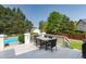 Inviting outdoor deck featuring a dining table with ample seating overlooking lush greenery and pool at 4245 S Dawson St, Aurora, CO 80014