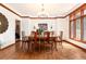 Formal dining room with hardwood floors, crown molding, chandelier, and a large window for natural light at 4245 S Dawson St, Aurora, CO 80014