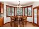 Cozy dining area with wood table and chairs; features a bay window with backyard views at 4245 S Dawson St, Aurora, CO 80014