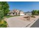 Beautiful tan brick home with a three car garage, circular driveway, and a xeriscaped front yard at 4245 S Dawson St, Aurora, CO 80014