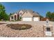 Beautiful tan brick home with a three car garage, concrete driveway, and a xeriscaped front yard at 4245 S Dawson St, Aurora, CO 80014