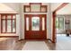 Inviting foyer with tile flooring, a glass paneled front door, a decorative rug, and views into other rooms at 4245 S Dawson St, Aurora, CO 80014