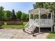 Charming white gazebo nestled in lush green backyard with stone patio and manicured landscaping at 4245 S Dawson St, Aurora, CO 80014
