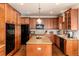 Spacious kitchen showcasing wood cabinets, an island, and modern appliances at 4245 S Dawson St, Aurora, CO 80014
