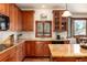 Well-equipped kitchen features wood cabinetry, granite countertops, and stainless steel appliances at 4245 S Dawson St, Aurora, CO 80014
