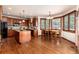 Open-concept kitchen and dining area with hardwood floors and abundant natural light at 4245 S Dawson St, Aurora, CO 80014