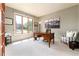 Comfortable office with white carpet, a large window, a wooden desk, and neutral-colored walls at 4245 S Dawson St, Aurora, CO 80014