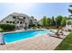 Spacious pool area with a patio, lounge chairs, and beautiful landscaping at 4245 S Dawson St, Aurora, CO 80014