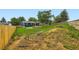 Large, grassy backyard featuring a rustic fence and outdoor entertainment area at 18662 E Brown Pl, Aurora, CO 80013
