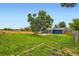 Large backyard with a covered patio and mature shade trees at 18662 E Brown Pl, Aurora, CO 80013