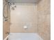 Shower-over-tub features a tan tile surround and chrome fixtures at 18662 E Brown Pl, Aurora, CO 80013