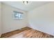 This bedroom features neutral walls, hardwood floors, and a window for natural light at 18662 E Brown Pl, Aurora, CO 80013