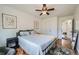 Bright bedroom features hardwood floors, ceiling fan, a double bed, and neutral walls at 18662 E Brown Pl, Aurora, CO 80013