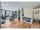 Open dining area featuring hardwood floors, storage shelves, and a seamless transition to the kitchen at 18662 E Brown Pl, Aurora, CO 80013