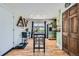 Open-concept dining area featuring wood floors, a table with stools, and a view to the backyard at 18662 E Brown Pl, Aurora, CO 80013
