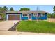 Charming single-story home with blue stucco exterior, brown garage door, and well-maintained front yard at 18662 E Brown Pl, Aurora, CO 80013