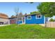 The exterior of this blue home features manicured grass, a brown garage door, and white trim around the windows at 18662 E Brown Pl, Aurora, CO 80013