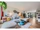 Inviting living room with a large sectional sofa, wood floors, and stylish decor at 18662 E Brown Pl, Aurora, CO 80013