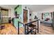 Open floor plan showcasing the kitchen with green cabinets connecting to the dining and living areas at 18662 E Brown Pl, Aurora, CO 80013